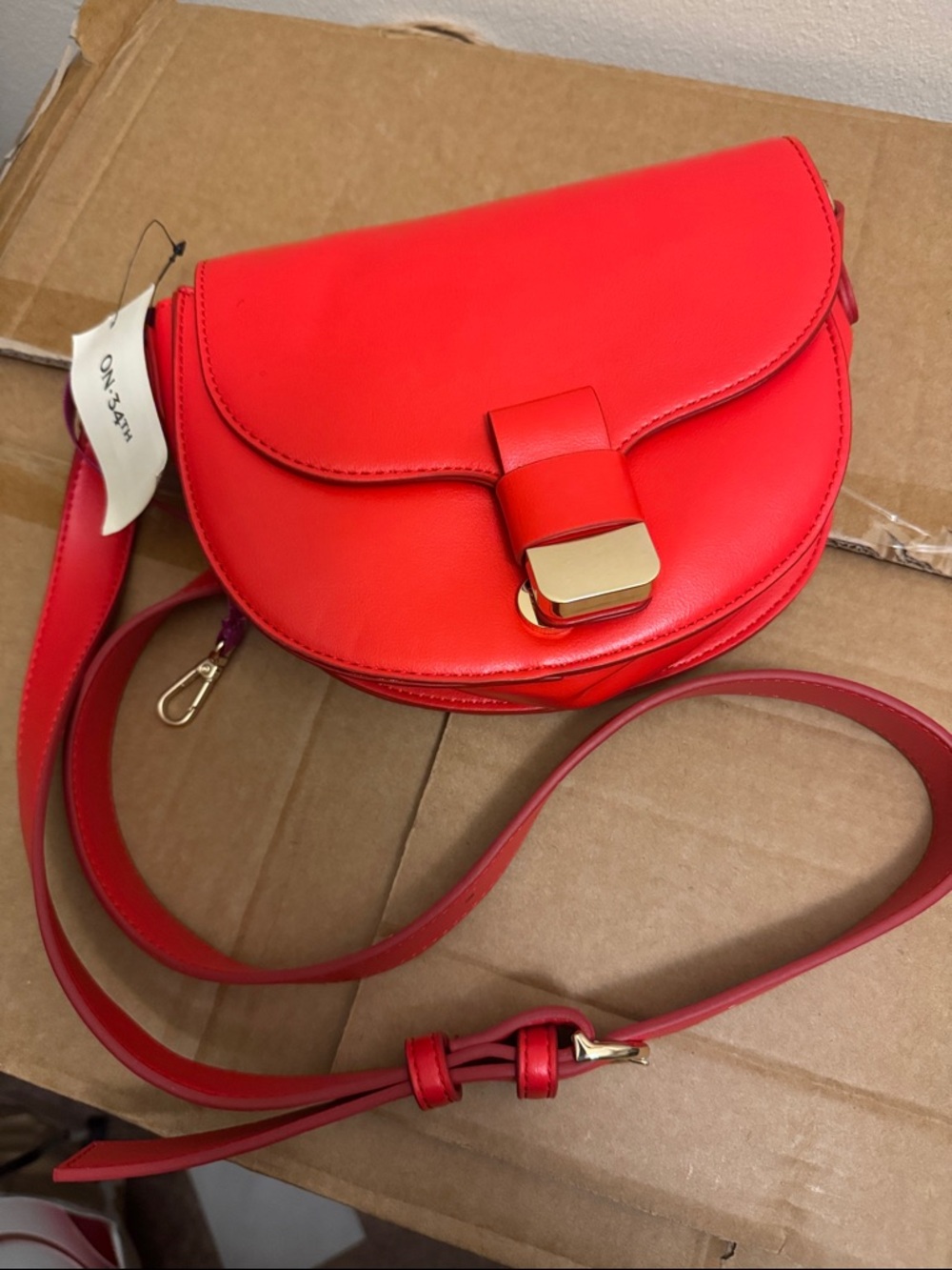 Sleek Red Saddle Crossbody with Gold Hardware